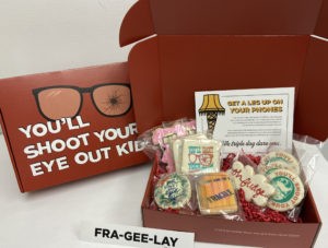 Red box with themed cookies and brand items inside